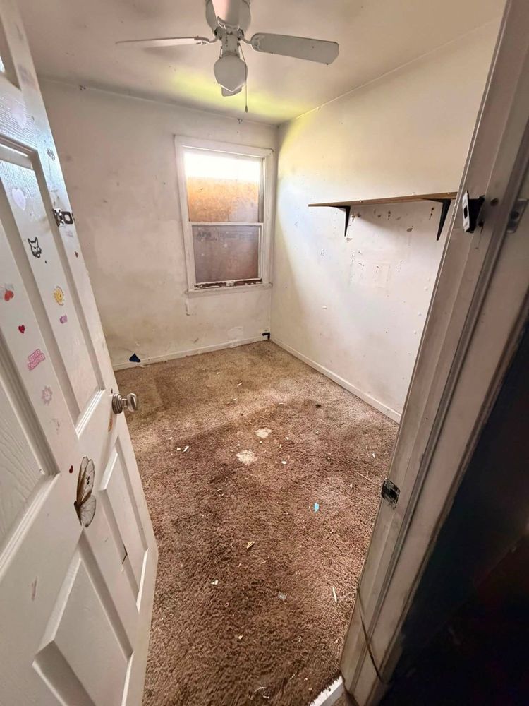 The same Elkton child&rsquo;s bedroom cleared out, showing bare carpet, an empty wall shelf and the sticker-covered door